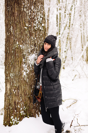 Girl in winter forestの写真素材