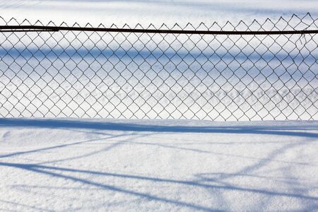 mesh fence in winterの写真素材