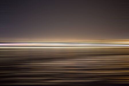 Abstract night city with reflection in water. Motion blur abstract background with horizontal stripesの写真素材