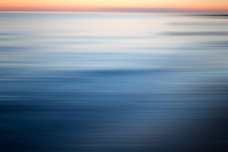 Abstract sea at sunset. Motion blur abstract background with horizontal stripesの写真素材