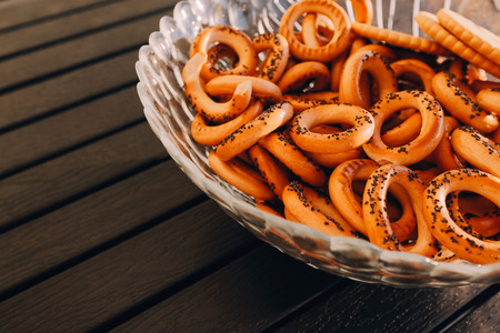 Bagels with poppy seeds on a plate on the black tableの写真素材