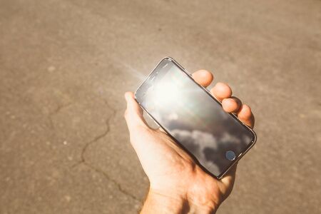 Smartphone with broken screen in hand. cracked screen.