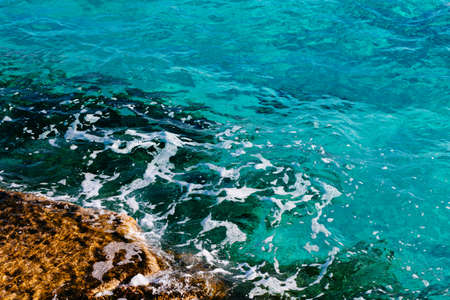 turquoise sea water and stone coast Cyprusの写真素材
