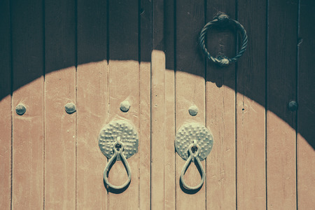 Ancient dusty closed doors. large closed wooden door closeupの写真素材