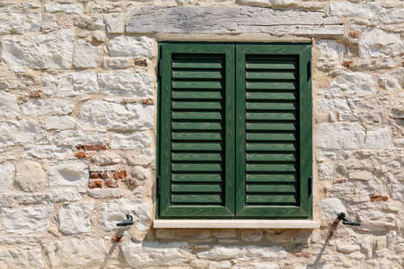 Closed green wooden window shutters. green window closeupの写真素材