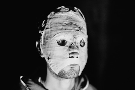 Black and white photo of a maniac in a mask closeup.の写真素材