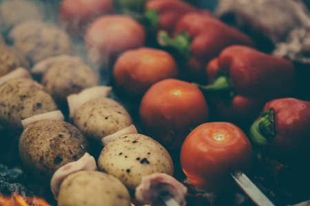 Veggies on barbeque tomatoes, red bell pepper, potatoes on coals, mangalの写真素材