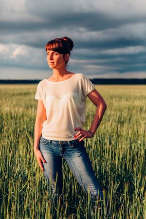 Beautiful girl posing in nature in the field.の写真素材