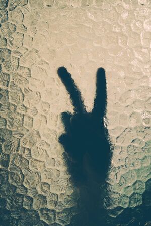 silhouette of the hand behind the glassの写真素材