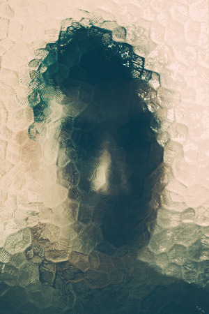 scary man behind the glass. maniac behind the glassの写真素材