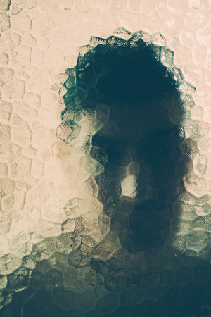 scary man behind the glass. maniac behind the glassの写真素材