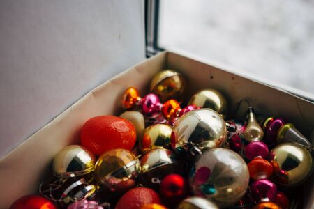Closeup view of many beautiful christmas or new year fir tree decoration colorful toys in box.の写真素材