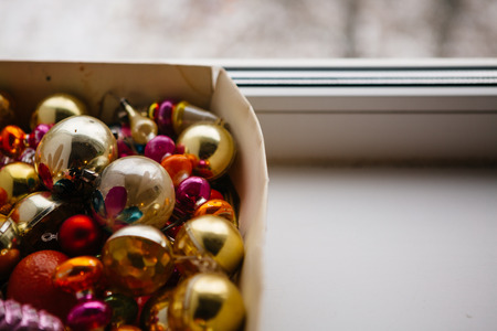 Closeup view of many beautiful christmas or new year fir tree decoration colorful toys in box.の写真素材