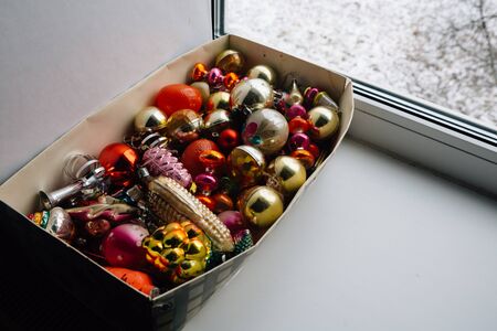 Closeup view of many beautiful christmas or new year fir tree decoration colorful toys in box.の写真素材