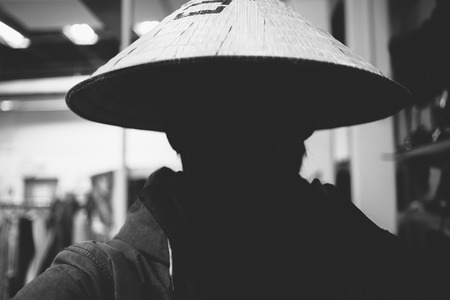 Silhouette of the person in a rice hat. Close up photo.の写真素材