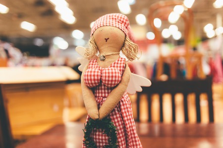 Doll in a dress from it is red and white cages made of fabric. Close up photo.の写真素材