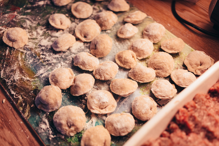 Raw Meat dumplings Russian traditional pelmeni with meat. Close up photo.の写真素材