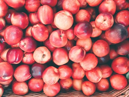 Background with ripe red peaches. Top view photo.の写真素材