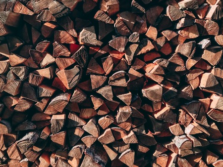 Photo of dry chopped firewood logs in a pile. Outdoors photo.の写真素材