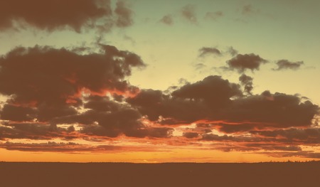 Sky and clouds in shades of orange color. Outdoors photo.の写真素材