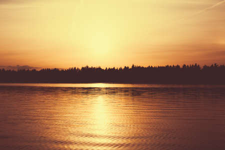 Beautiful landscape of forest and lake in the evening.の写真素材