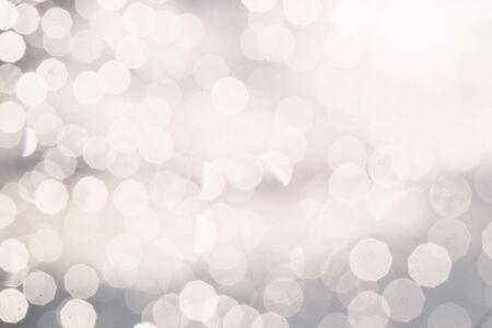 Shiny silver background with glowing blurred circles.の写真素材