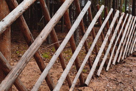 Beautiful wooden fence in the village. Daytime photo.の写真素材