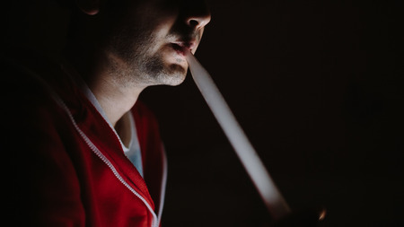hookah smoking in the darkness. Man smokes in the darkの写真素材