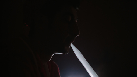 hookah smoking in the darkness. Man smokes in the dark
