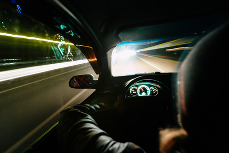 Driving at night. View from inside the car. Photo with a long exposure. Taken with a wide-angle optics.の写真素材