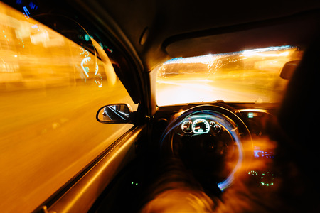 Driving at night. View from inside the car. Photo with a long exposure. Taken with a wide-angle optics.の写真素材