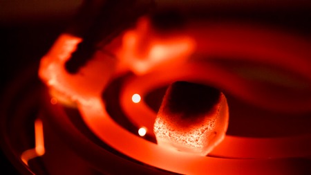 Blazing red-coconut charcoal in a dark room
