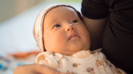 little baby close-up. Baby in his mother's hands closeupの写真素材