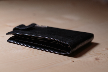 Black men's wallet on the table close-upの写真素材