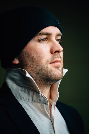 Portrait of a young man in a jacket and hat