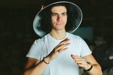 Portrait of a young man in a strange unusual hatの写真素材