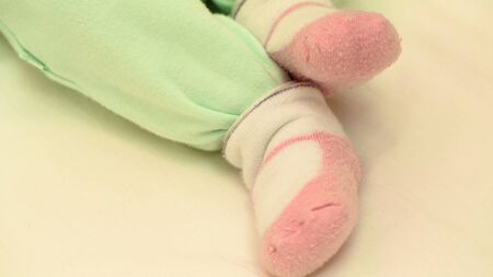 Feet baby pants and socks close up