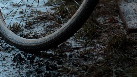 old bicycle standing outside the house under the snow