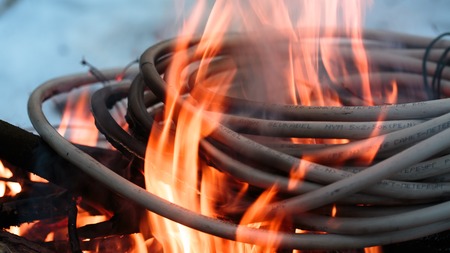 wires on fire. Firing winding insulation of electrical wiring in the fire in the winter woods