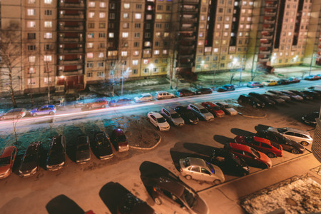 Car parking in the courtyard of apartment buildings at night Tilt Shift. miniature effectの写真素材