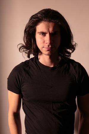 Brutal man in black with long hair. Nice photo.