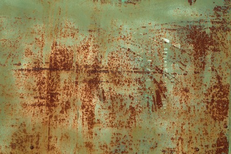 Green colored rusty stained metal wall texture pattern.