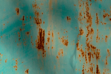 Colored rusty stained metal wall texture pattern. Close up photo.の写真素材