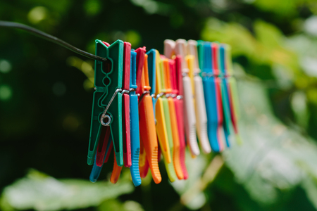 Colorful group of clothespins on a rope. Photo in the daytime.の写真素材