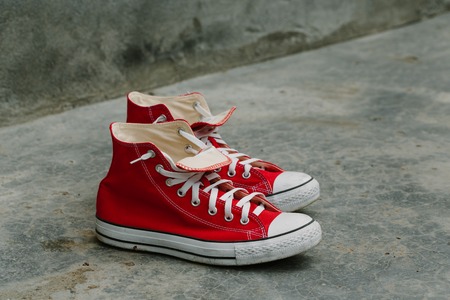 Pair of red shoes on concrete. Photo in the daytime.の写真素材