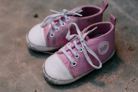 Old baby sneakers closeup photo.の写真素材