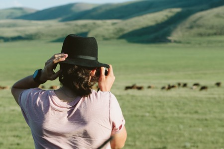 Photographer holds a camera and photographs. Back view.の写真素材
