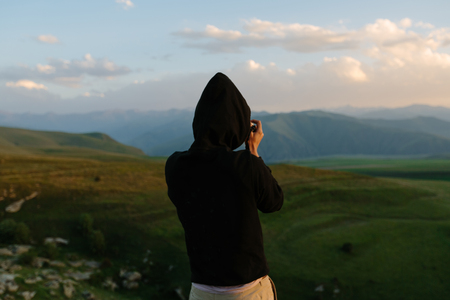 Photographer holds a camera and photographs.の写真素材