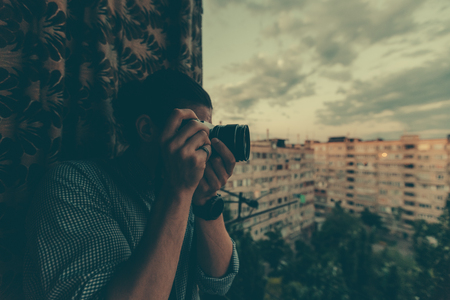 Photographer holds a camera and photographs.の写真素材