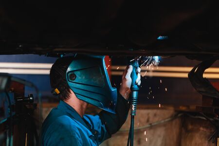Man in a mask does welding machines.の写真素材